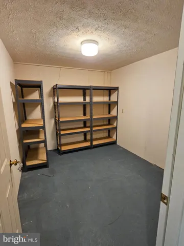 a view of room with stairs and closet