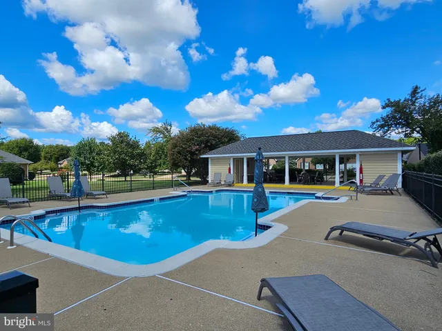 a view of a house with swimming pool and sitting area