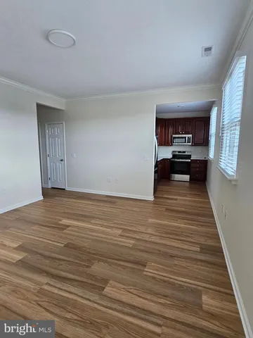a view of a living room kitchen and a wooden floor