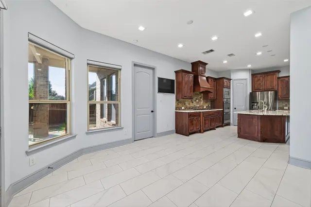 a kitchen with stainless steel appliances granite countertop a stove and a sink