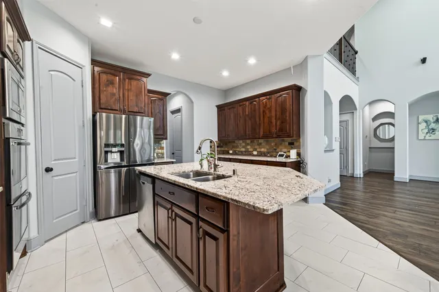 a bathroom with a granite countertop toilet sink and mirror
