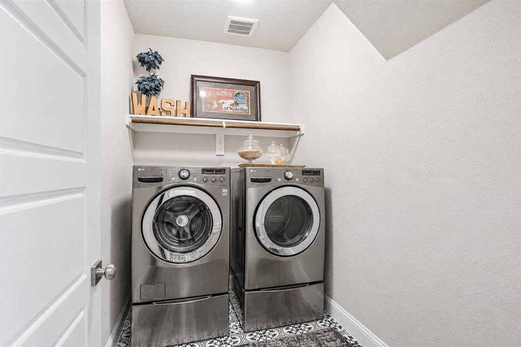25 Morrison Road Howe, TX 75459 - Photo 13 of 27 Dedicated laundry area featuring a patterned floor tile, overhead shelving, and a bright white door