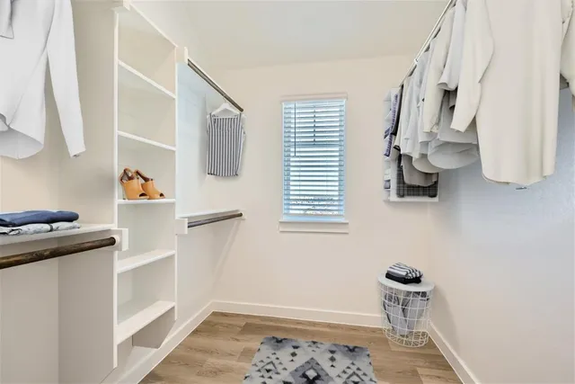 a bedroom with a window and storage space