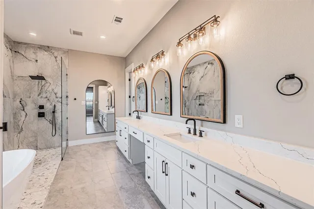 a spacious bathroom with a double vanity sink and a mirror