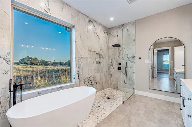 a bathroom with a bathtub and a shower