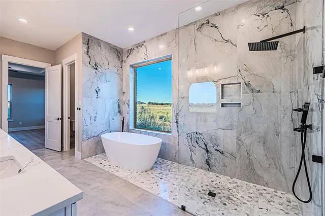 a spacious bathroom with a bathtub and shower