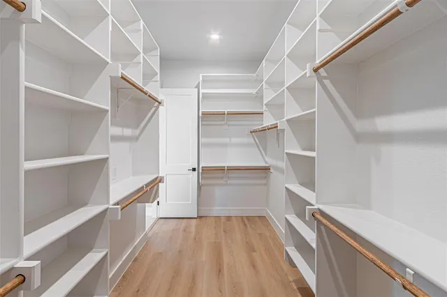 a view of walk in closet with empty racks
