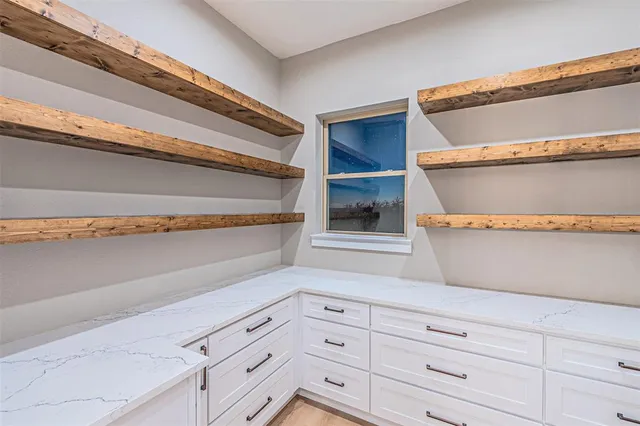 a view of white cabinets and a wooden floor
