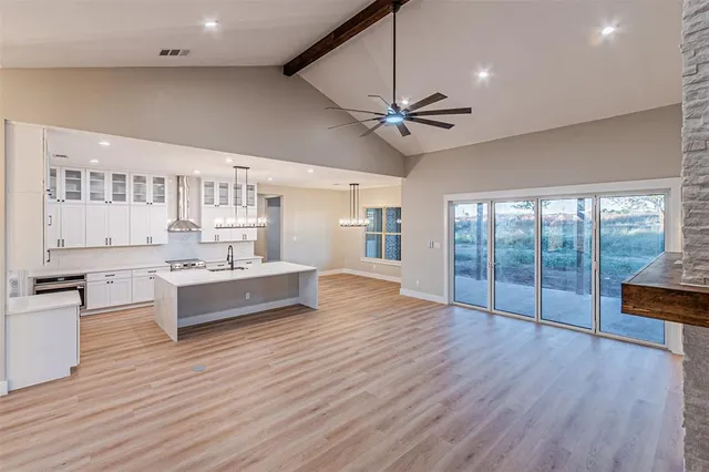 a large kitchen with kitchen island a large counter space and stainless steel appliances