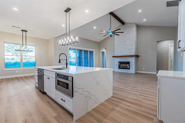 a view of kitchen with sink microwave and stove top oven