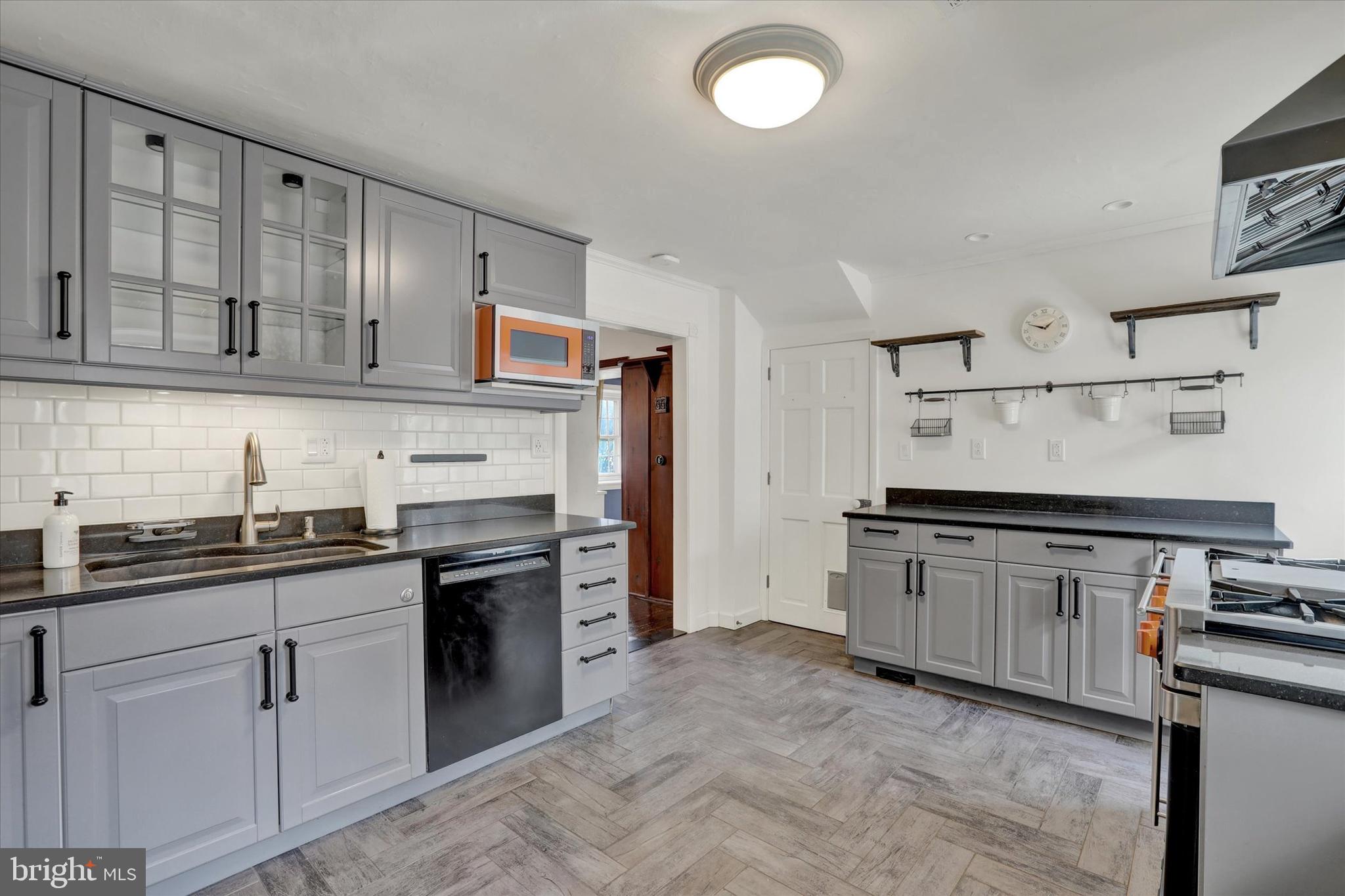 60 Quarry Road Doylestown, PA 18901 - Photo 20 of 70 a kitchen with granite countertop a sink stove and cabinets