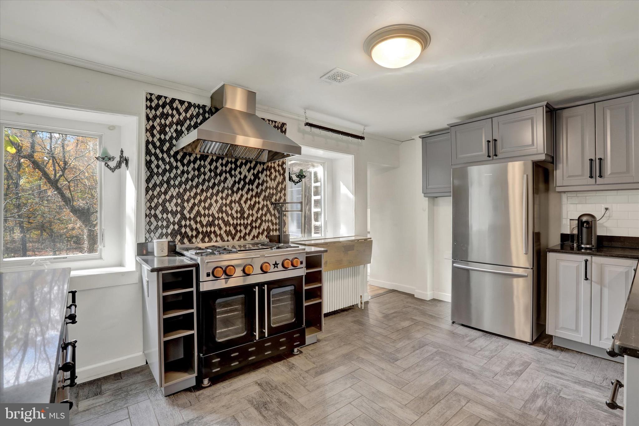60 Quarry Road Doylestown, PA 18901 - Photo 21 of 70 a kitchen with stainless steel appliances granite countertop a stove and a refrigerator