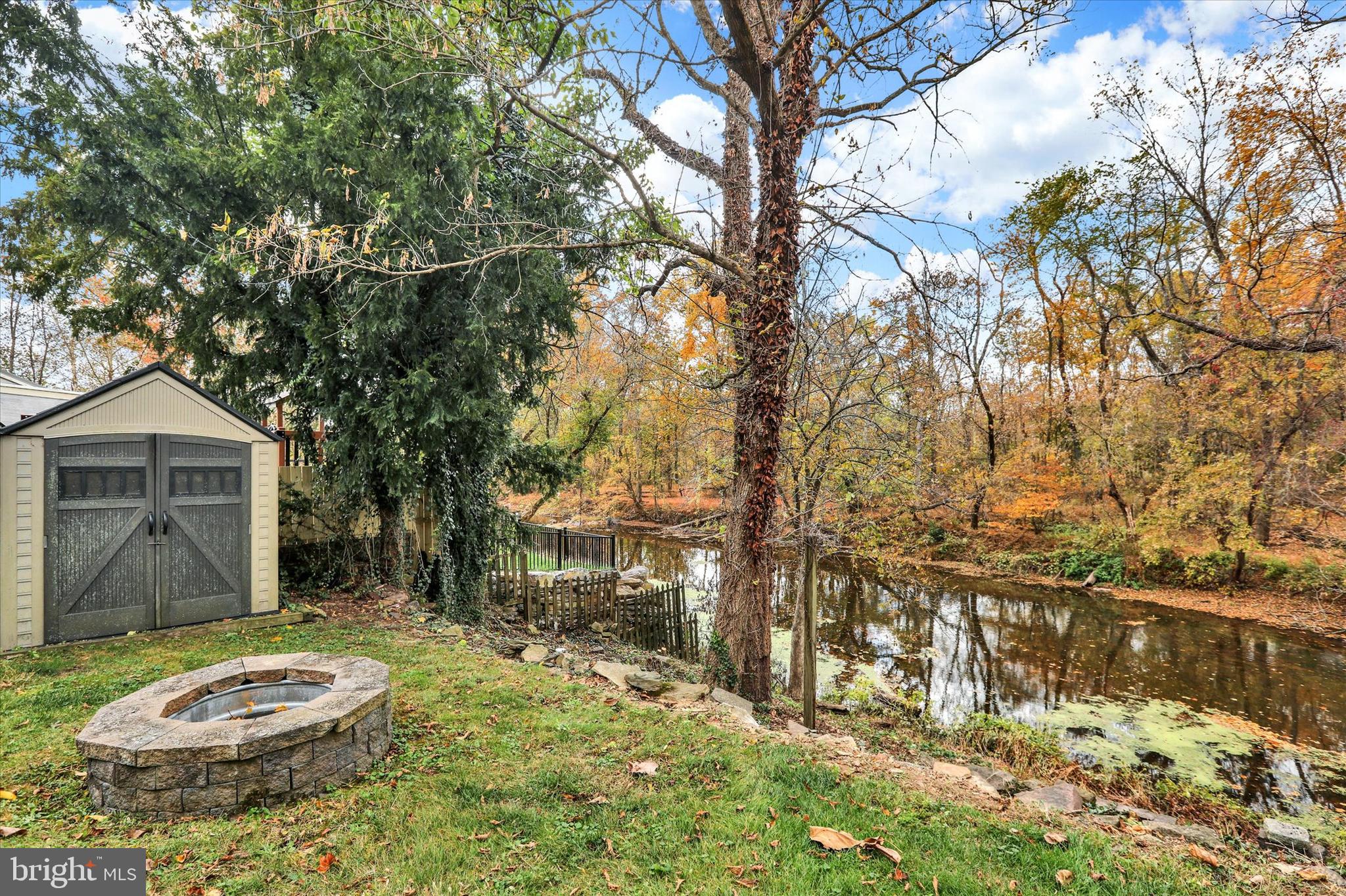 60 Quarry Road Doylestown, PA 18901 - Photo 8 of 70 a backyard of a house with table and chairs under an umbrella