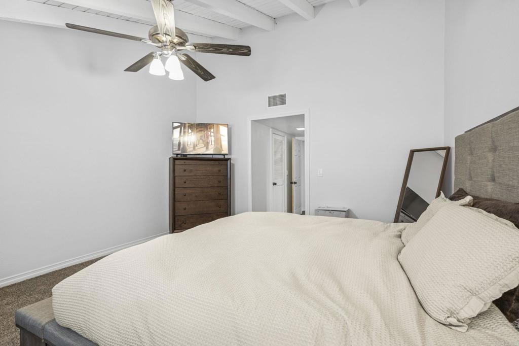 3404 Oak Cliff Drive, Unit 8 Fallbrook, CA 92028 - Photo 24 of 39 a bedroom with a bed and a chandelier