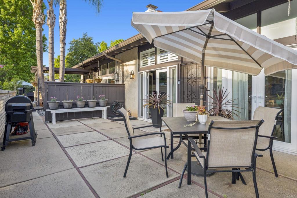 3404 Oak Cliff Drive, Unit 8 Fallbrook, CA 92028 - Photo 29 of 39 a view of a patio with table and chairs and potted plants