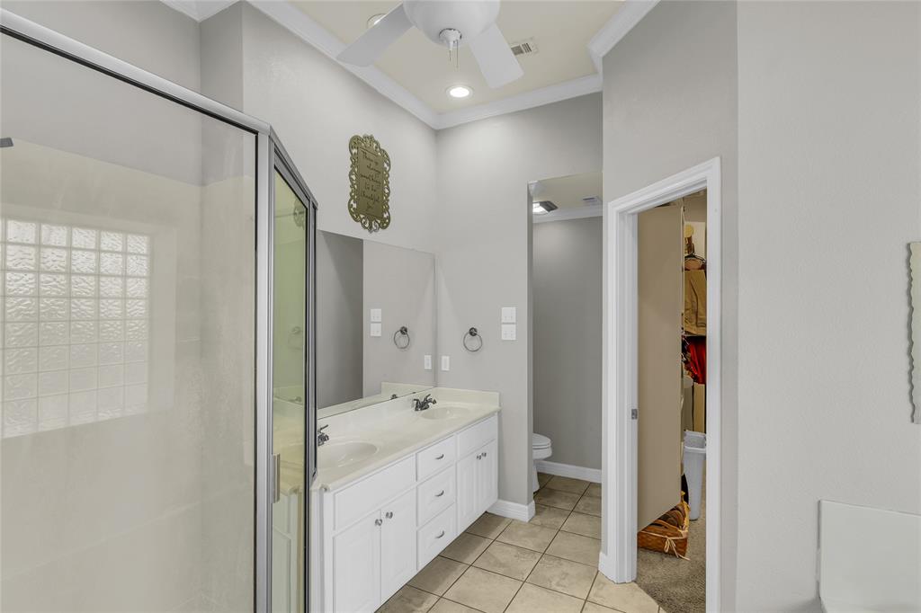 5613 Landsdown Drive Waco, TX 76708 - Photo 16 of 27 a bathroom with a mirror sink and vanity