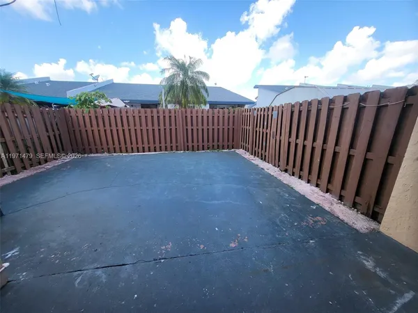 a view of a porch with wooden fence