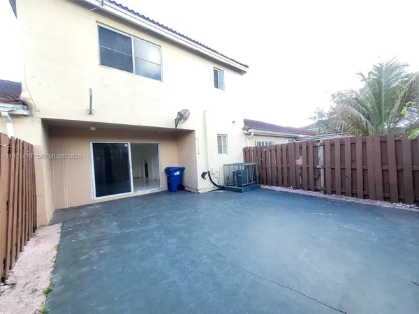 a view of a house with wooden fence