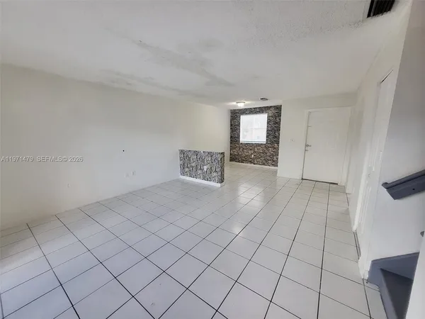 a view of an empty room and window