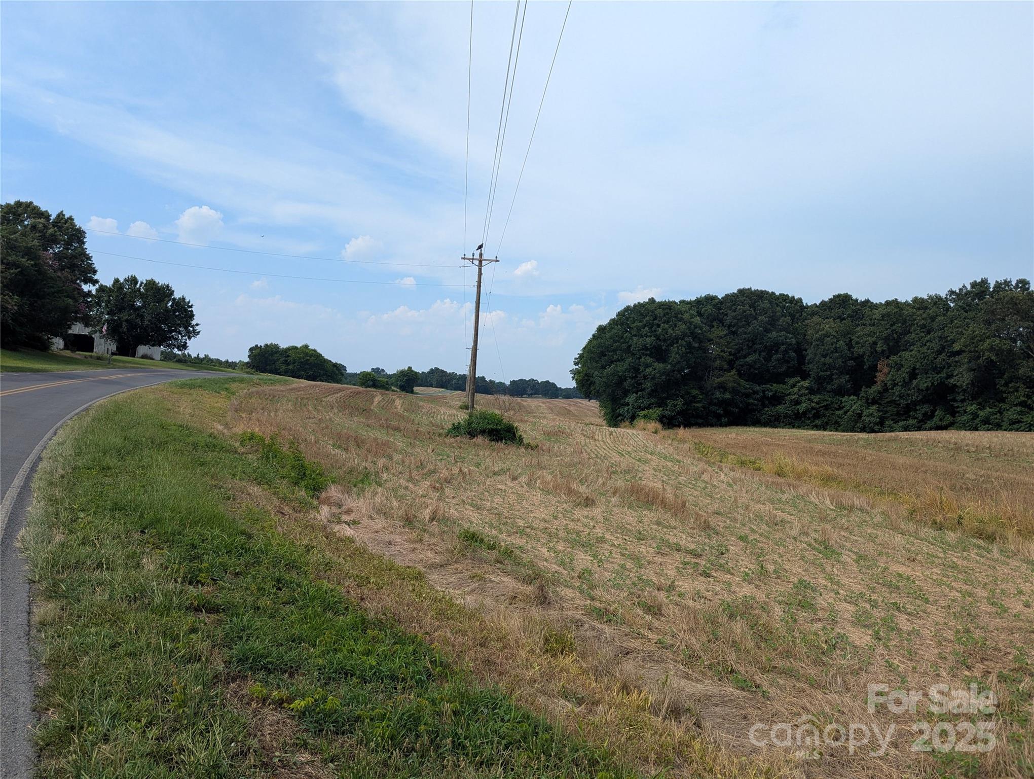 1455 Bonnie Ross Road Polkton, NC 28135 - Photo 12 of 18 a view of a field with an ocean in the background