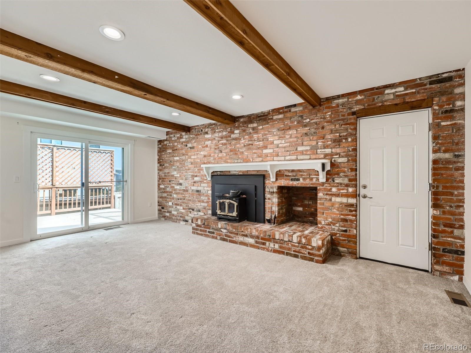 6124 Powell Road Parker, CO 80134 - Photo 15 of 50 a view of an empty room with a fireplace and a window