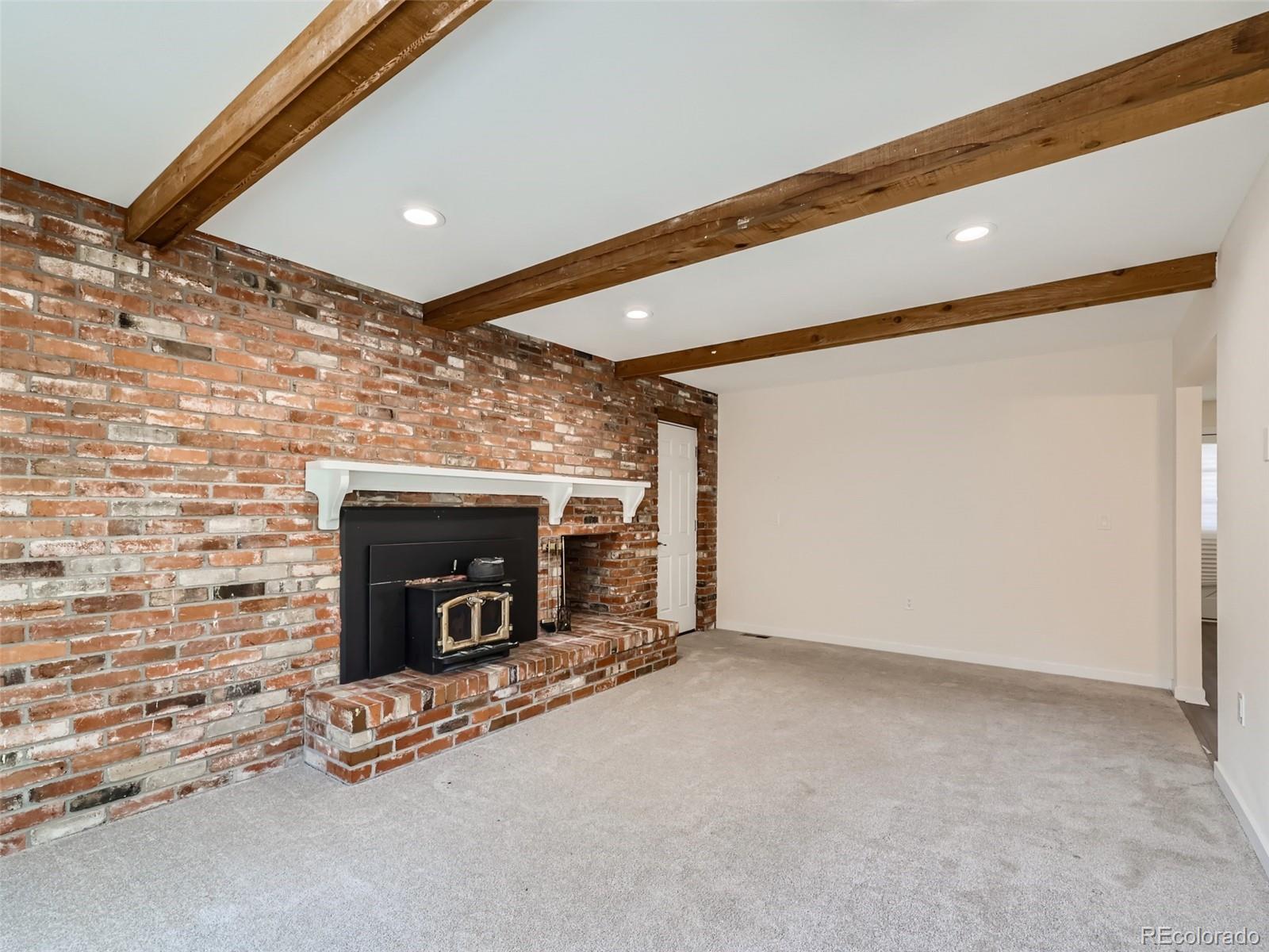 6124 Powell Road Parker, CO 80134 - Photo 16 of 50 a view of an empty room with a fireplace
