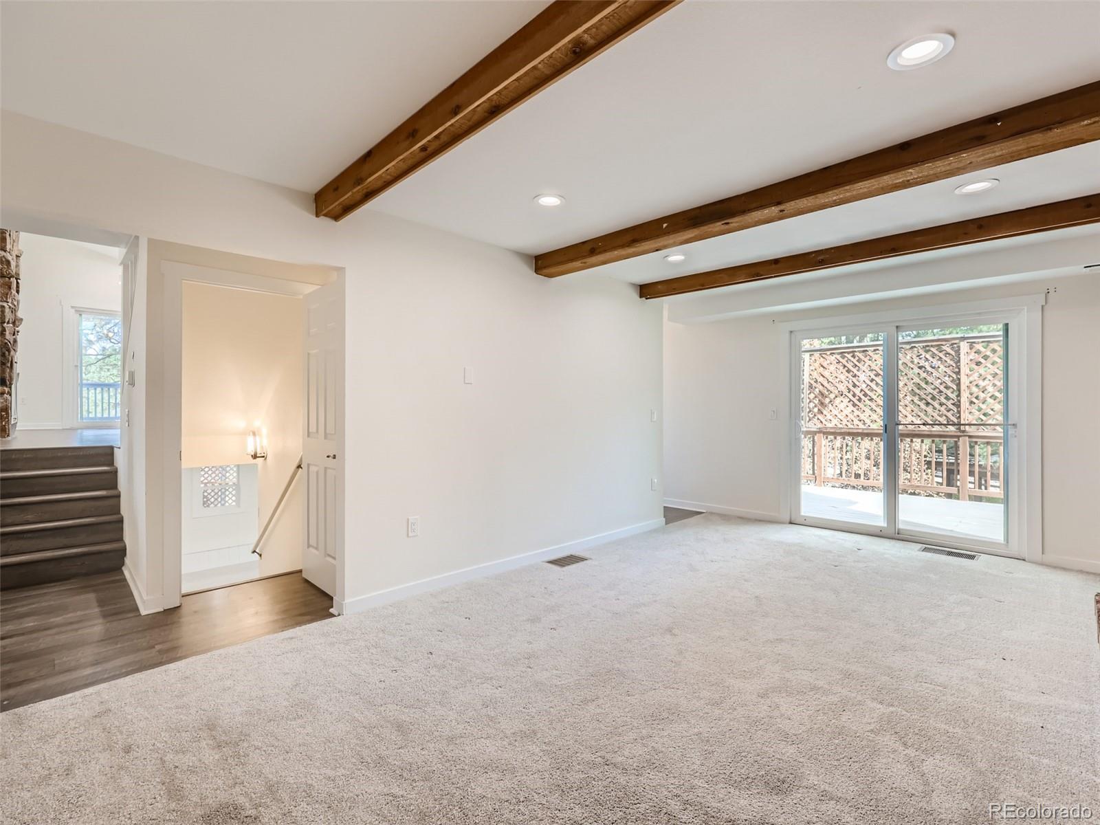 6124 Powell Road Parker, CO 80134 - Photo 17 of 50 an empty room with wooden floor and windows