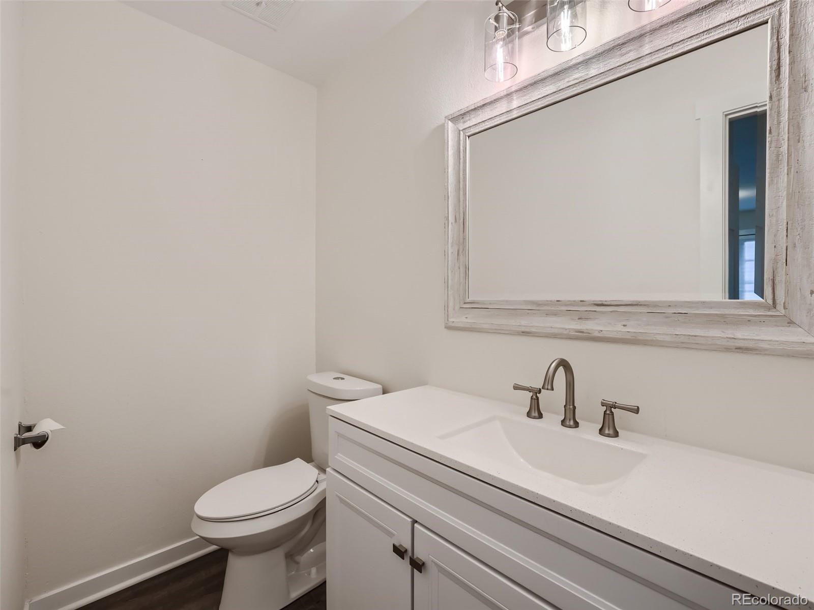 6124 Powell Road Parker, CO 80134 - Photo 18 of 50 a bathroom with a sink a toilet and mirror