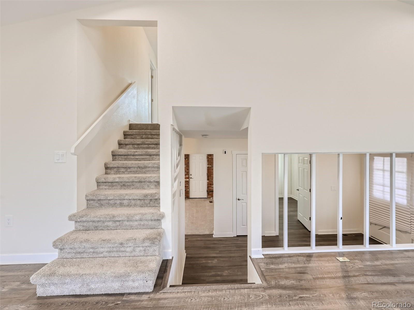 6124 Powell Road Parker, CO 80134 - Photo 19 of 50 a view of entryway and hall with wooden floor