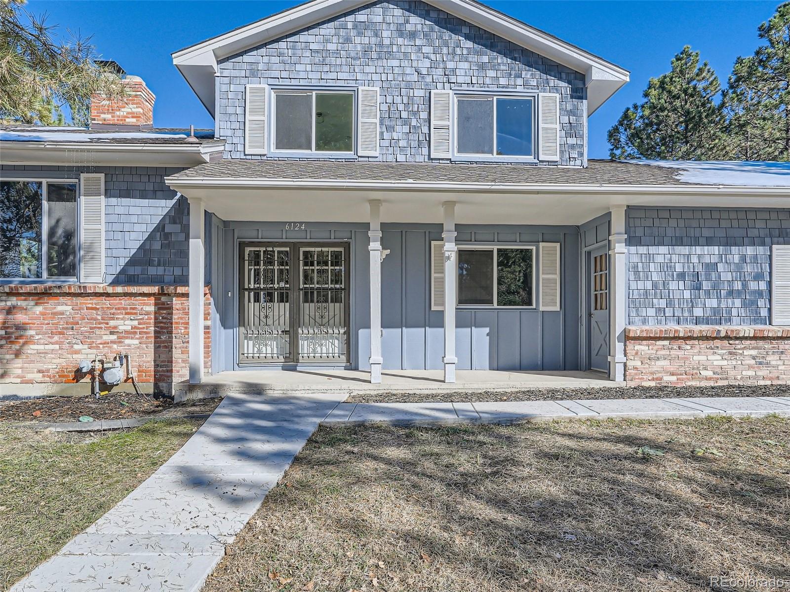 6124 Powell Road Parker, CO 80134 - Photo 2 of 50 a front view of a house with a yard and potted plants