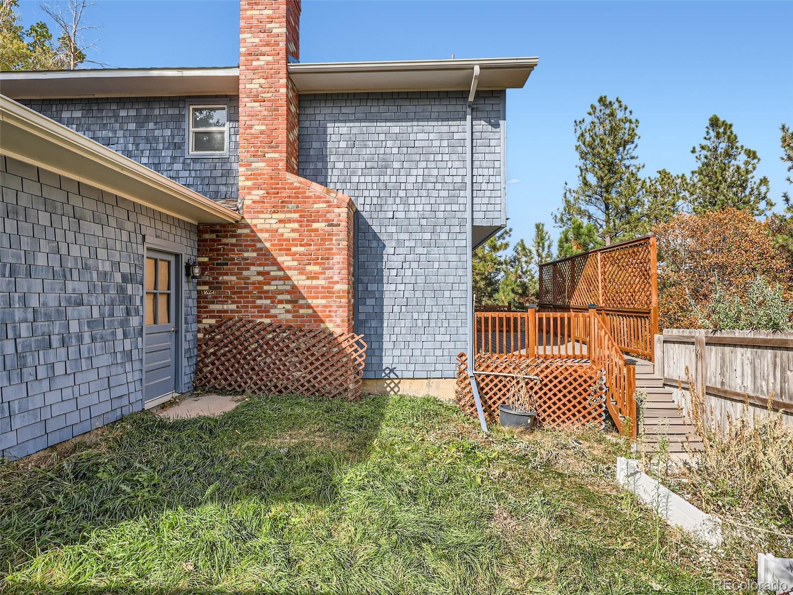 6124 Powell Road Parker, CO 80134 - Photo 36 of 50 a backyard of a house with a garden and deck