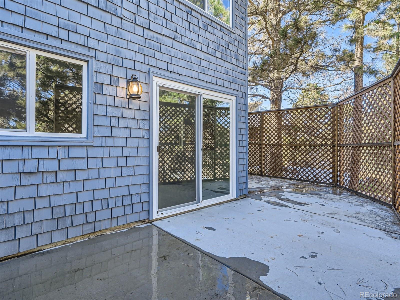 6124 Powell Road Parker, CO 80134 - Photo 37 of 50 a view of a backyard with brick wall and a potted plant