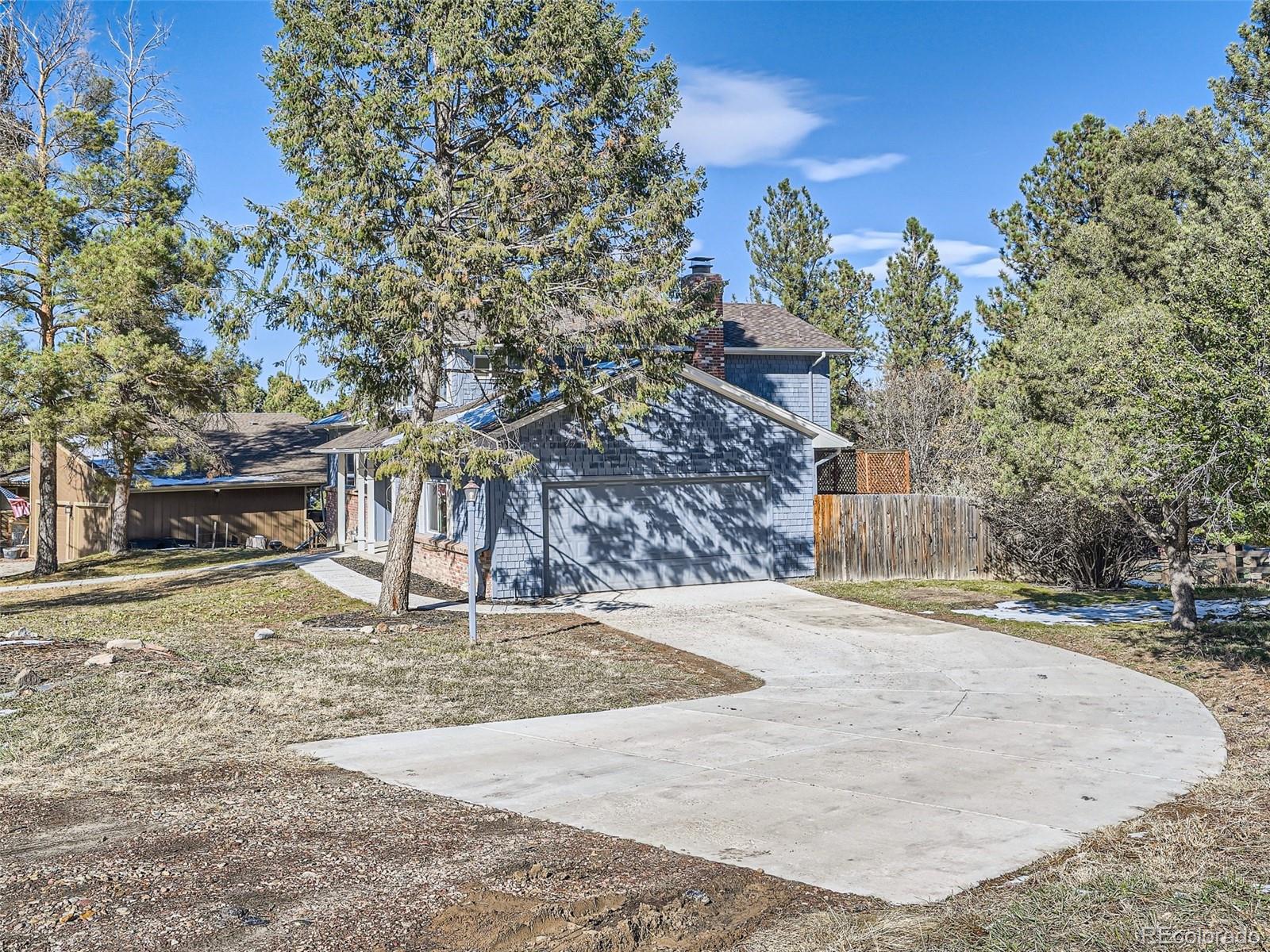 6124 Powell Road Parker, CO 80134 - Photo 4 of 50 a backyard of a house with large trees