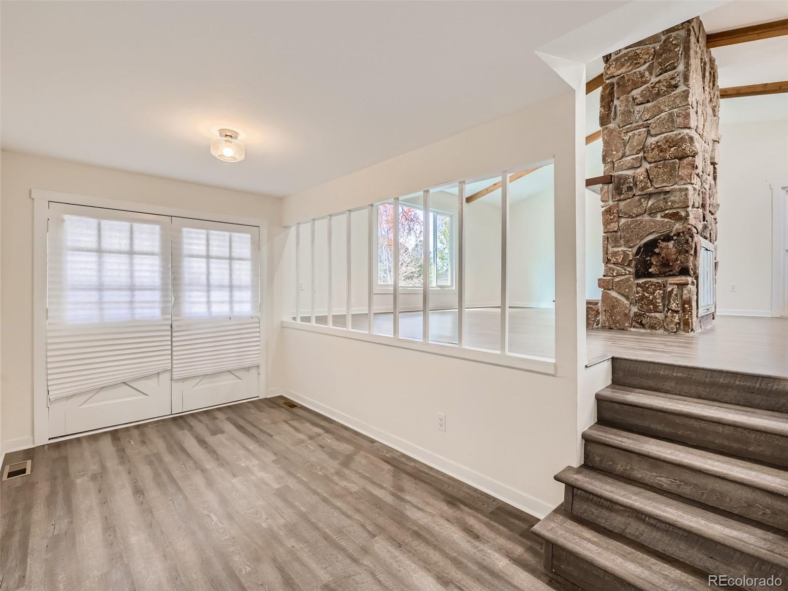 6124 Powell Road Parker, CO 80134 - Photo 5 of 50 a view of an empty room with wooden floor and a window