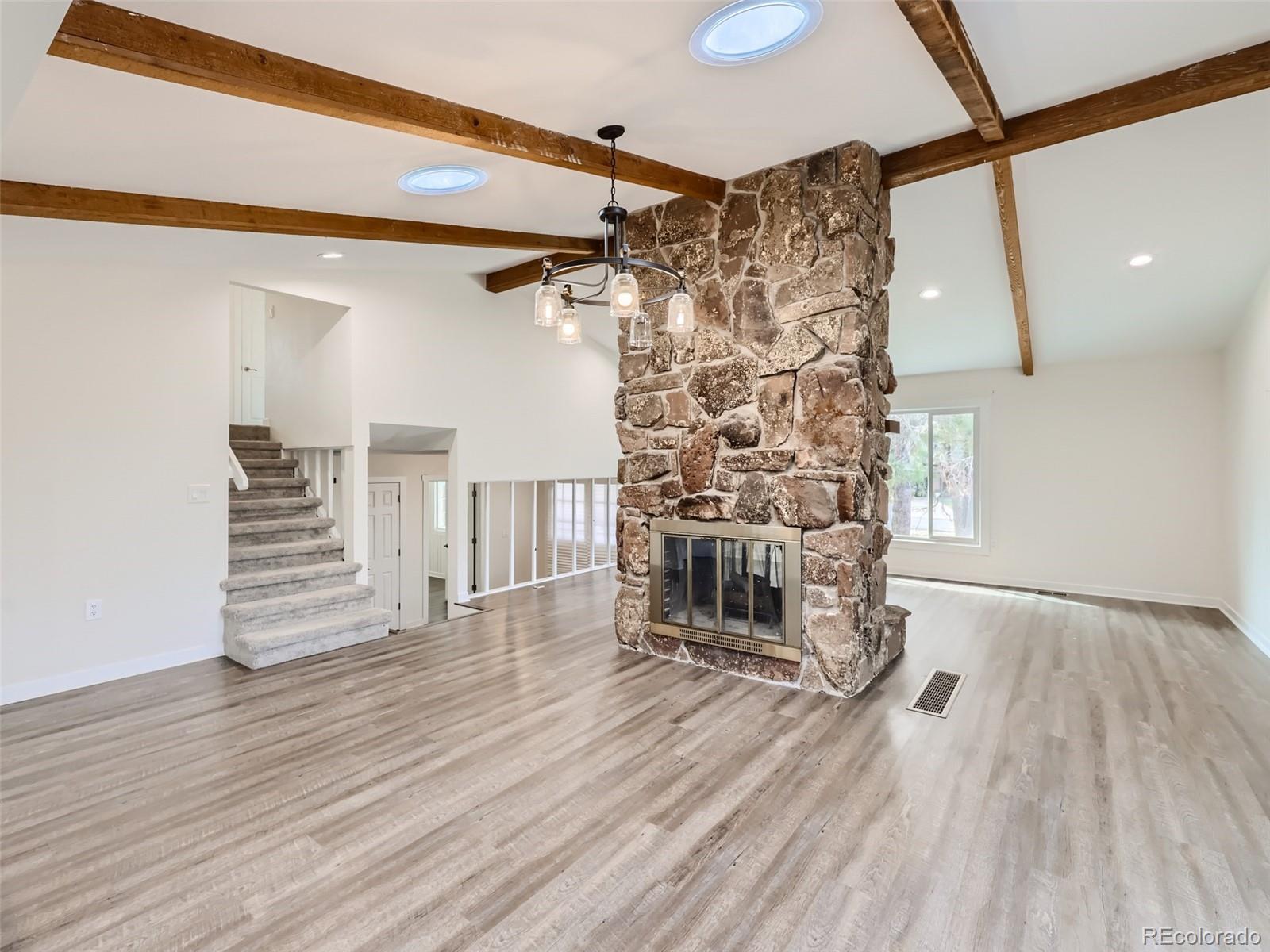 6124 Powell Road Parker, CO 80134 - Photo 8 of 50 a view of empty room with wooden floor and fan
