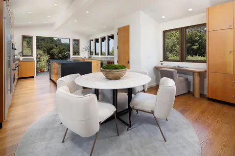 a living room with furniture a rug and a floor to ceiling window
