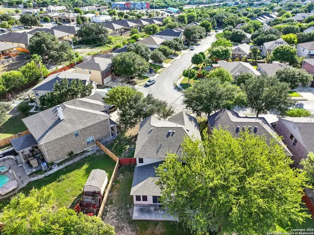 an aerial view of residential house with outdoor space and swimming pool