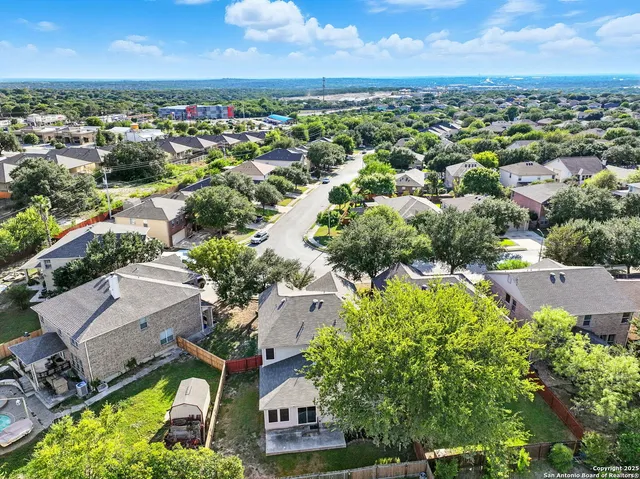 an aerial view of residential houses with outdoor space and river view