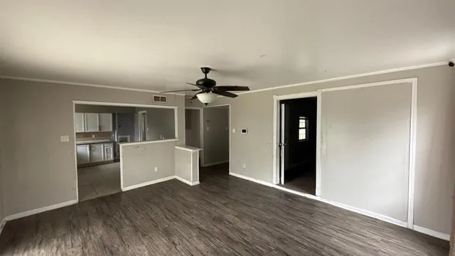 a view of a kitchen with wooden floor a sink and refrigerator