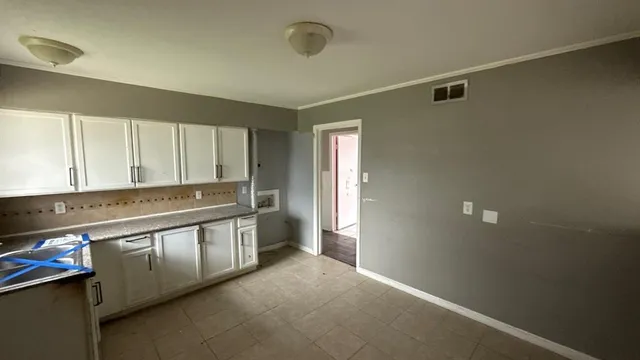 a view of a kitchen with stainless steel appliances granite countertop a stove and a refrigerator