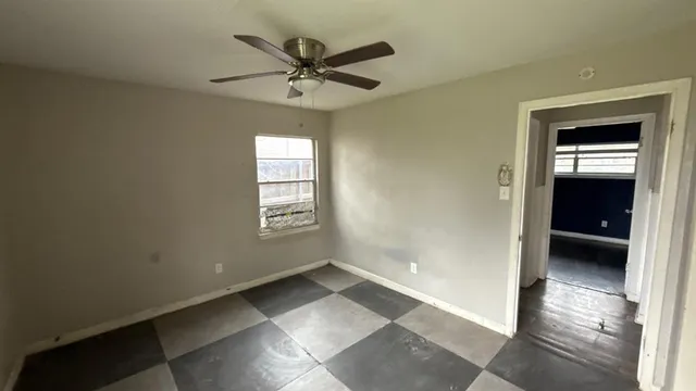 a view of a livingroom with a ceiling fan and window