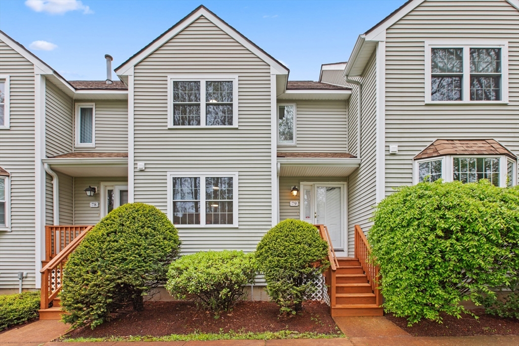 79 Patrick Road, Unit 79 Tewksbury, MA 01876 - Photo 1 of 18 a front view of a house with a yard and garage