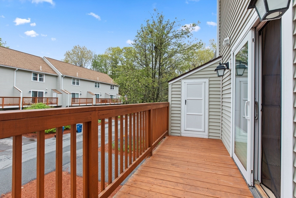 79 Patrick Road, Unit 79 Tewksbury, MA 01876 - Photo 15 of 18 a balcony view with wooden floor and fence