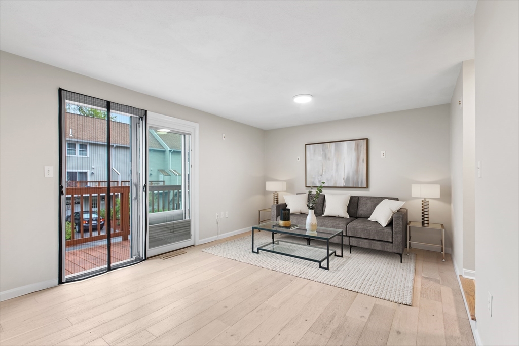 79 Patrick Road, Unit 79 Tewksbury, MA 01876 - Photo 4 of 18 a view of a livingroom with furniture and wooden floor
