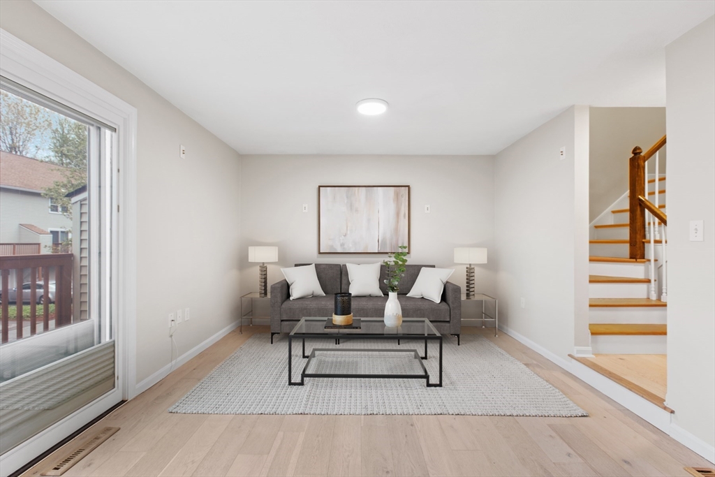 79 Patrick Road, Unit 79 Tewksbury, MA 01876 - Photo 5 of 18 a living room with furniture and a rug