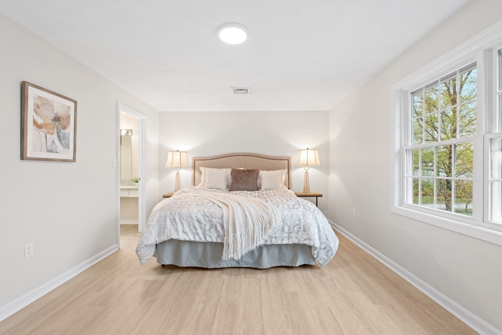 79 Patrick Road, Unit 79 Tewksbury, MA 01876 - Photo 10 of 18 a bedroom with a bed and a large window