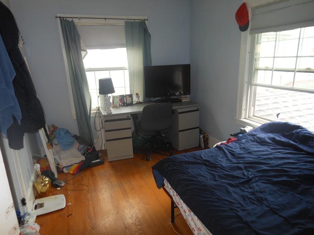 18 Pierce Street Malden, MA 02148 - Photo 11 of 29 a bedroom with a bed and a flat tv screen on the dresser