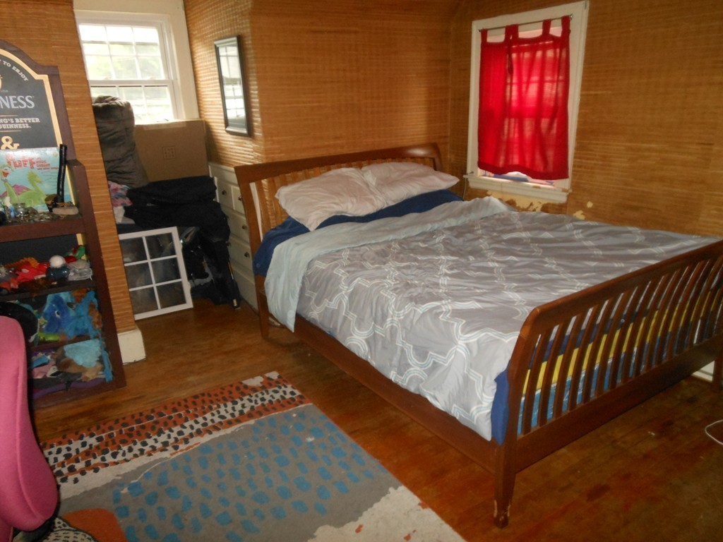 18 Pierce Street Malden, MA 02148 - Photo 14 of 29 a bed sitting in a bedroom next to a window