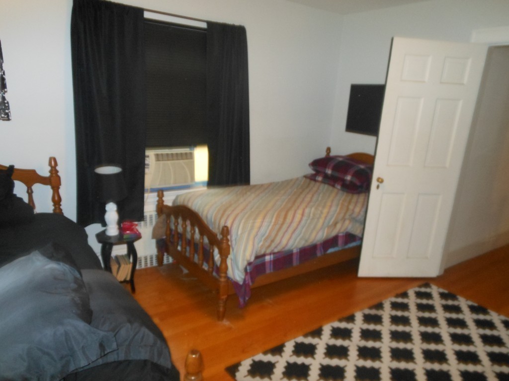 18 Pierce Street Malden, MA 02148 - Photo 15 of 29 a bedroom with a bed and wooden floor