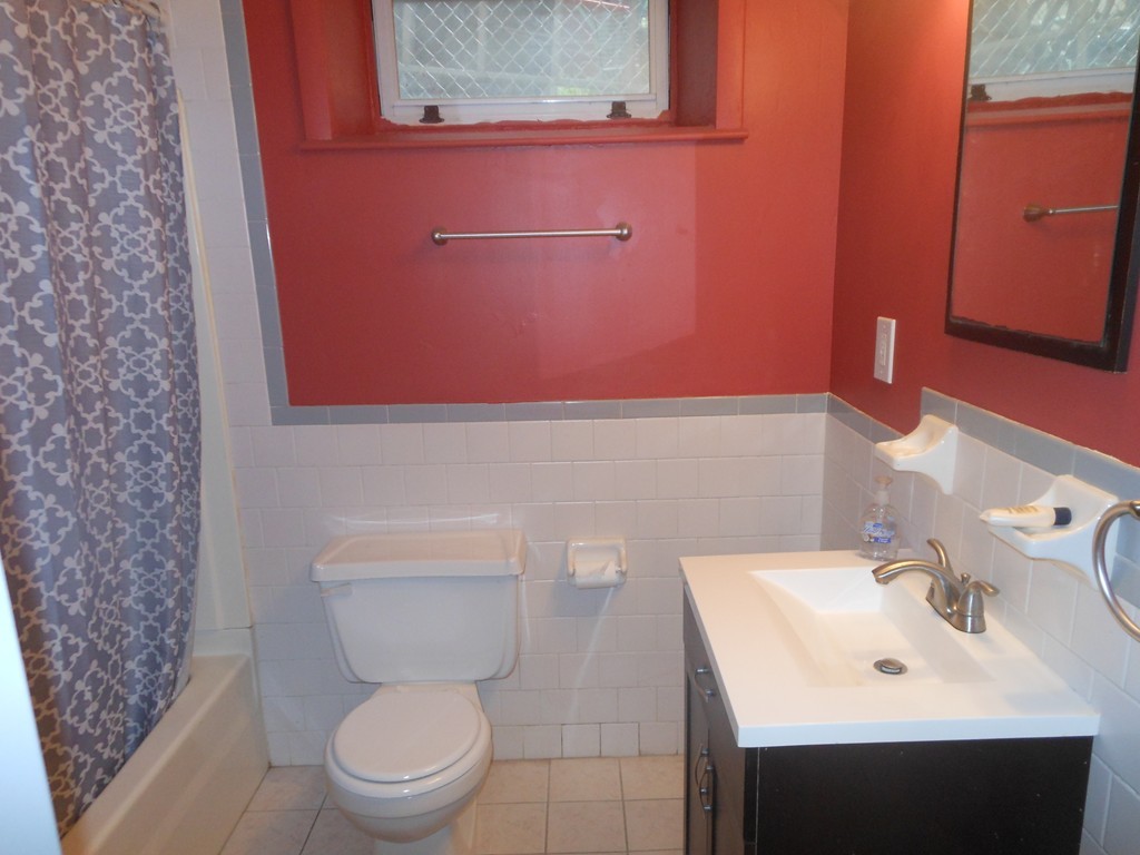 18 Pierce Street Malden, MA 02148 - Photo 20 of 29 a bathroom with a sink a toilet and a mirror